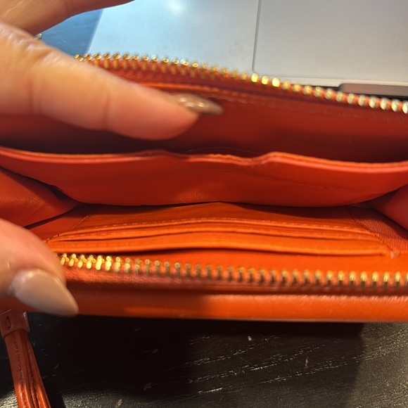 Tory Burch orange wallet wristlet with pink bow. - Picture 2 of 2